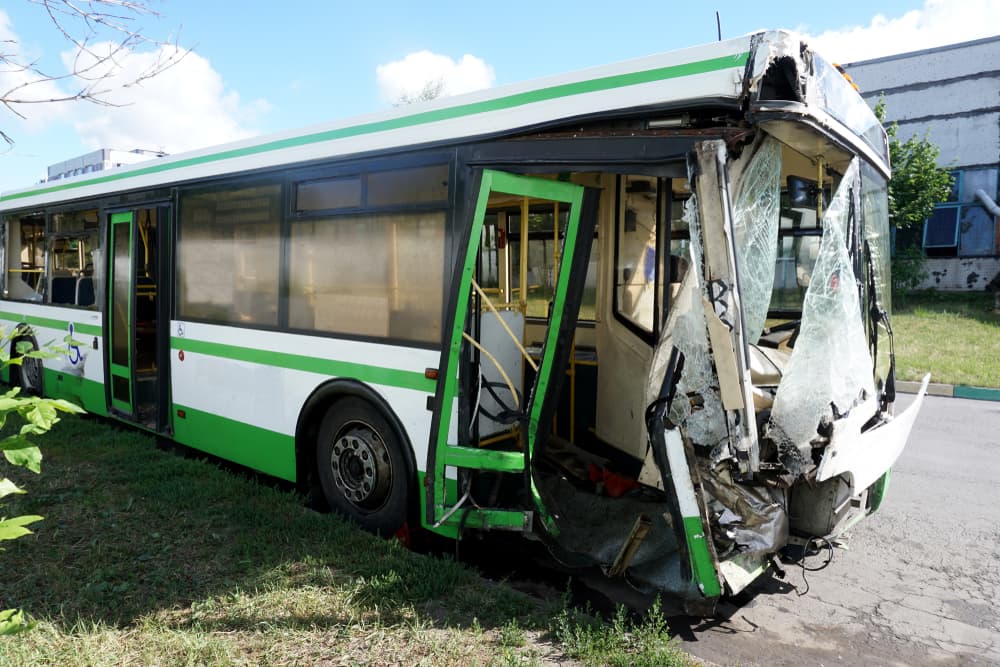The bus, damaged in an accident, now sits in the parking lot, a testament to the consequences of careless driving.