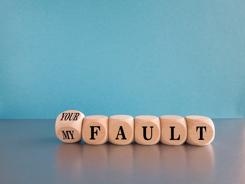 blocks spelling out 'your fault' or 'my fault'