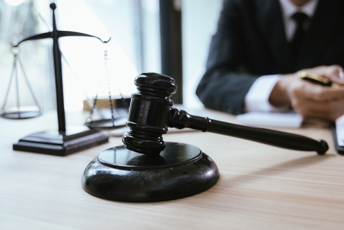 San Mateo wrongful termination lawyer reviewing case notes.
