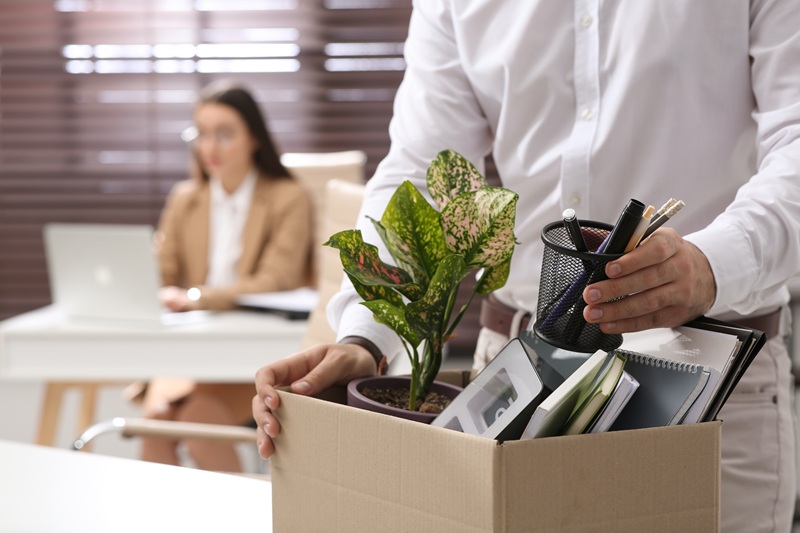 San Mateo employee packing his desk up after a wrongful termination
